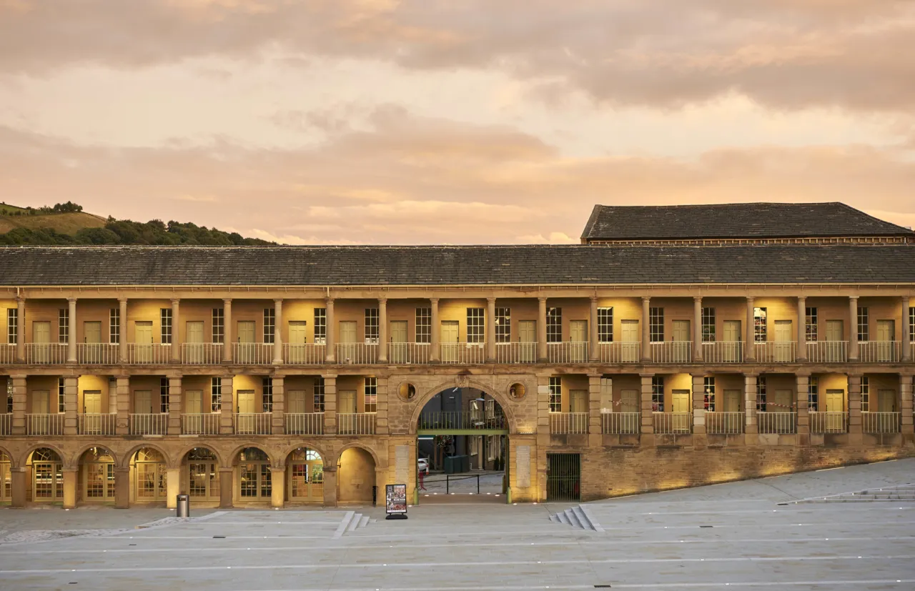 Restored historic façade and stone plaza at Piece Hall, Halifax, showcasing heritage-led public realm landscape architecture