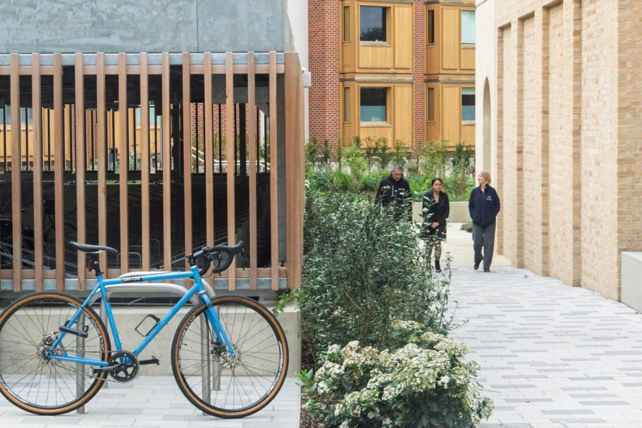 Schwarzman Centre for the Humanities Oxford with pedestrian walkway, greenery, and bicycle in foreground