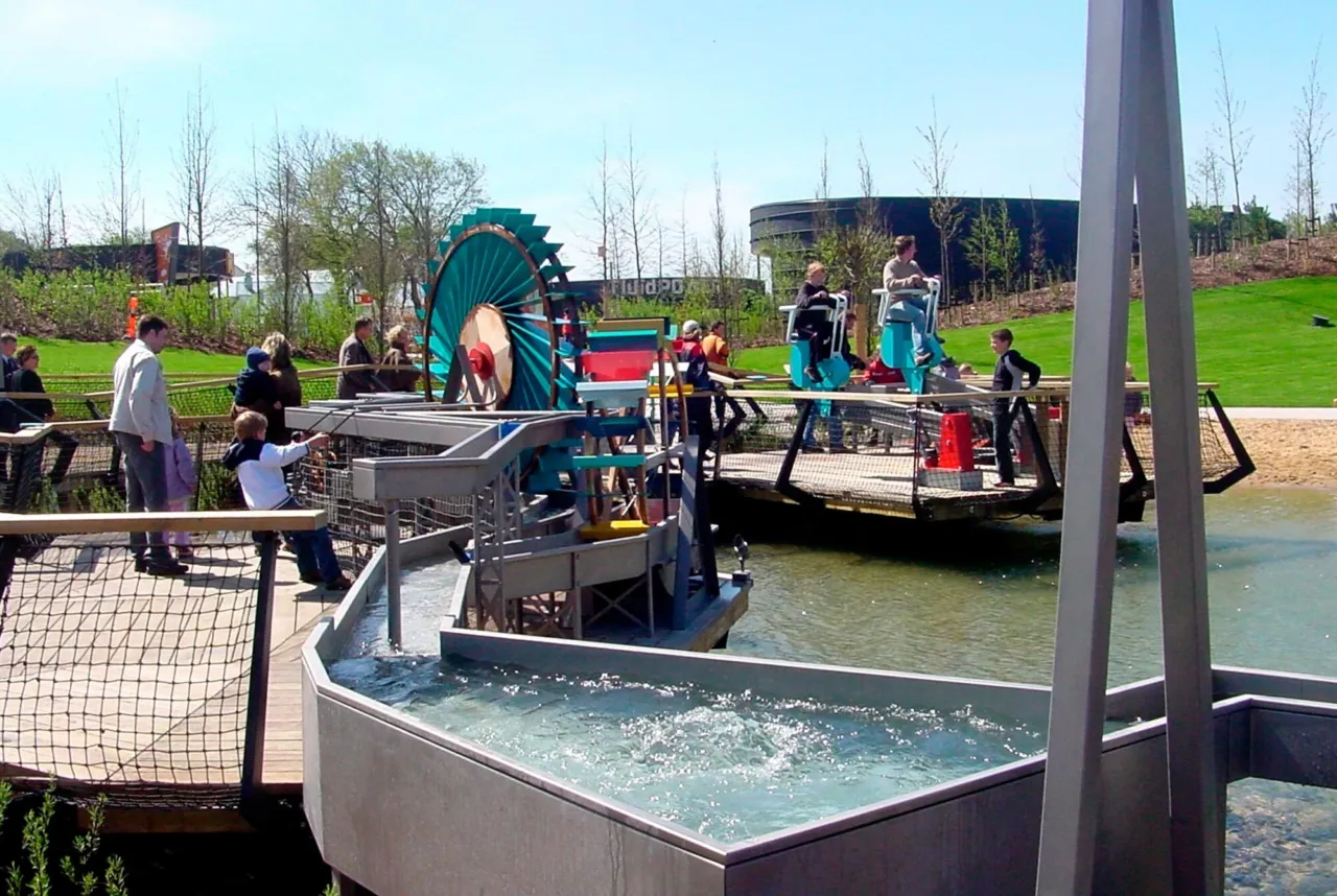 An arched woven willow tunnel creates playful spaces and sheltered enclosures for children to explore
