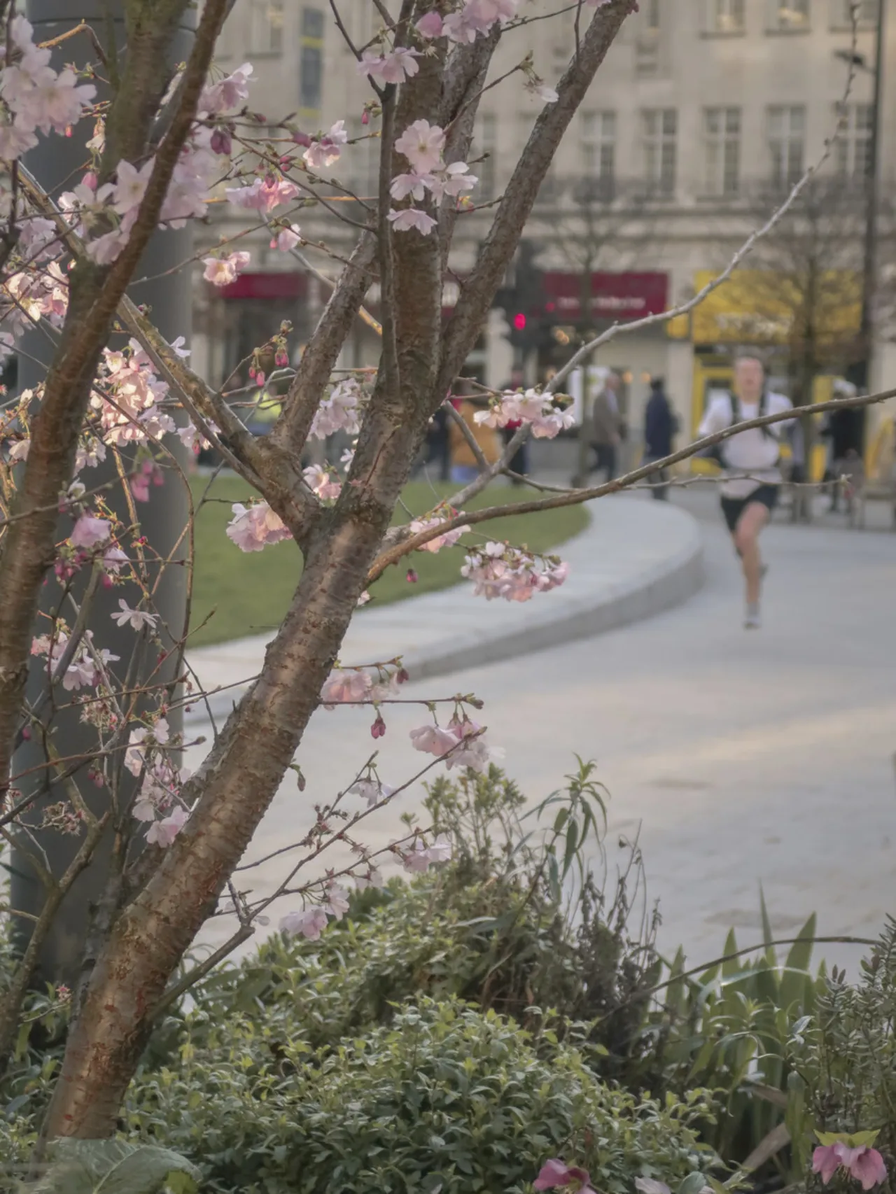 Runner in the background in Aldgate Public Realm