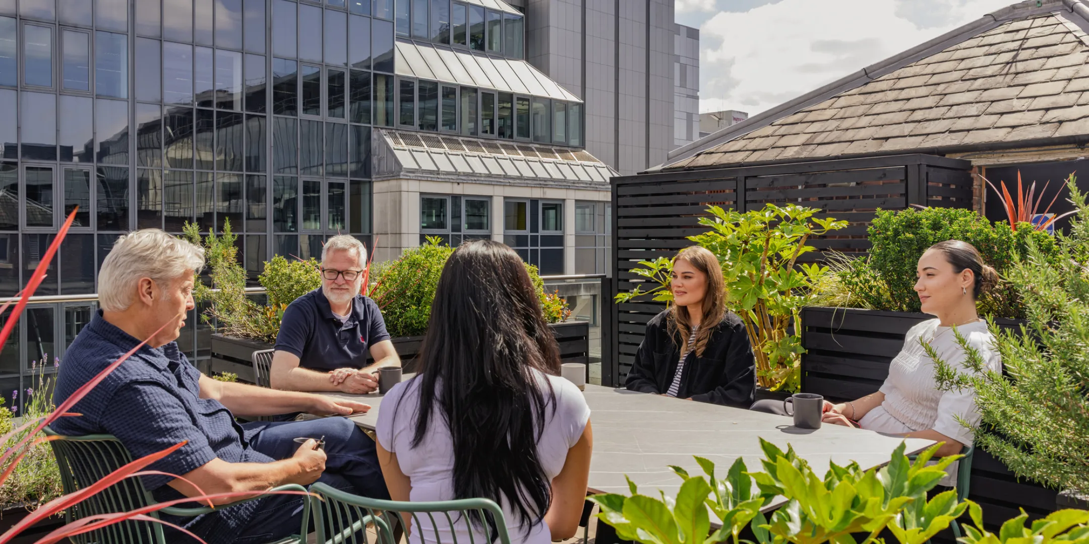 Gillespies team on their studio rooftop sitting around a table