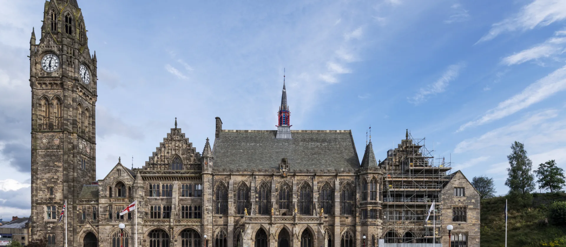 Rochdale Town Hall, with multiple pedestrians in the public square.