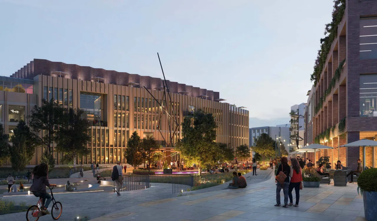 Evening view of Oxpens Oxford with active public realm, street planting, and landscape architecture in urban innovation district.