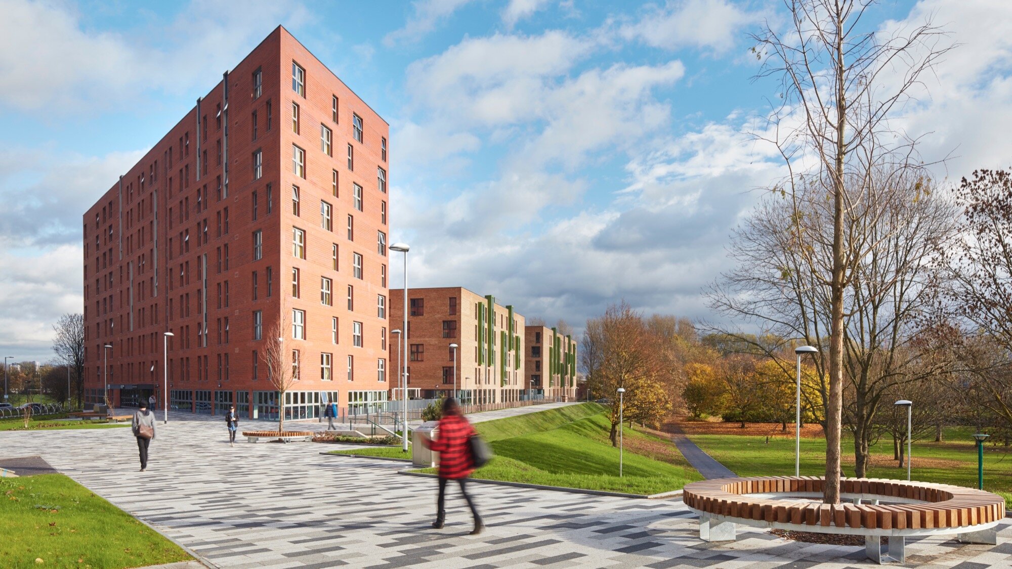 Peel Park Quarter public realm design with modern paving, tree planting, and contemporary street furniture for student housing landscape.