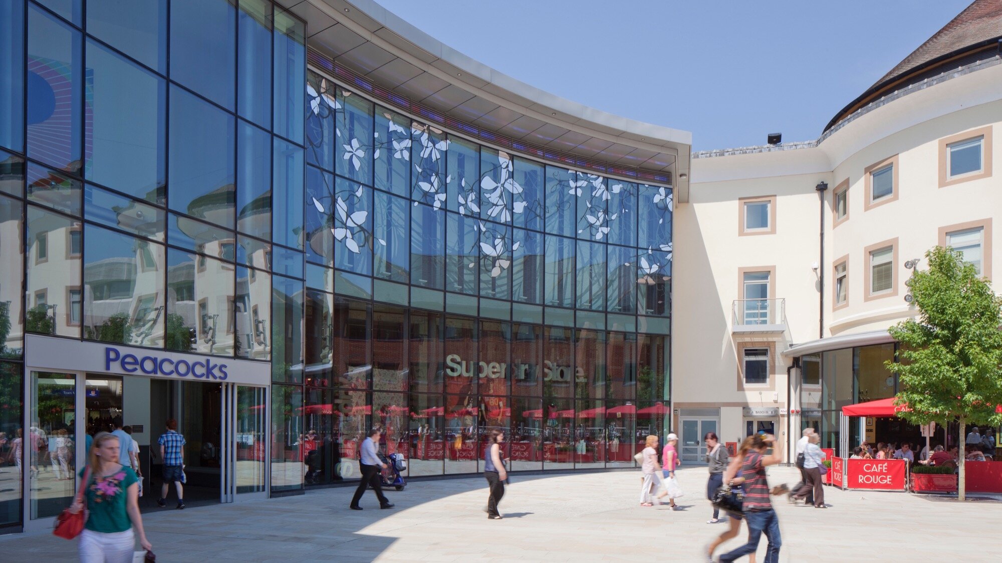 Woking Jubilee Square public realm with retail, cafes, and modern landscape architecture for urban placemaking
