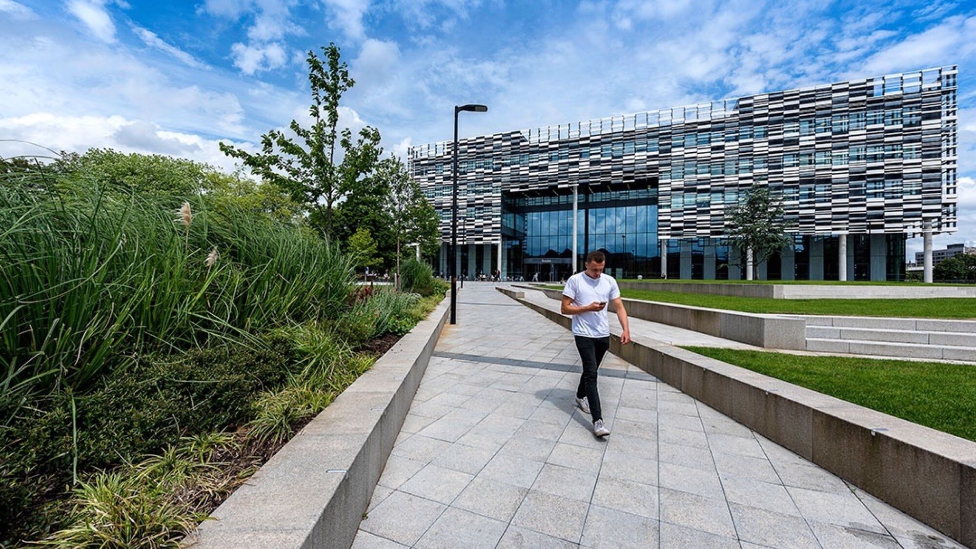 Birley Fields Campus landscape design with formal paving, structured planting, and open green space in Manchester.