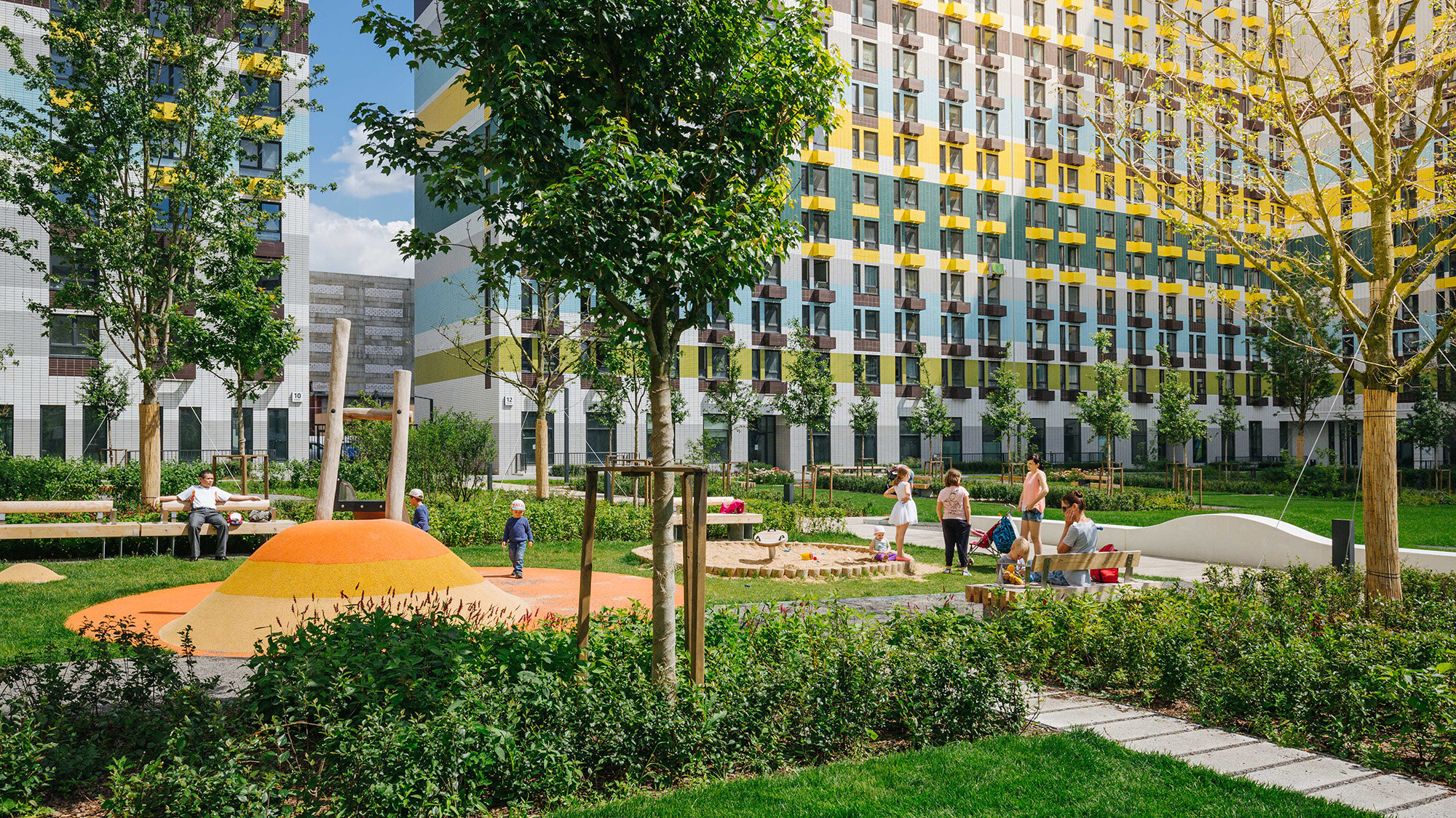 Urban residential landscape with playground, planting, and seating at Varshavskoe Shosse, Moscow, designed for family-friendly spaces.