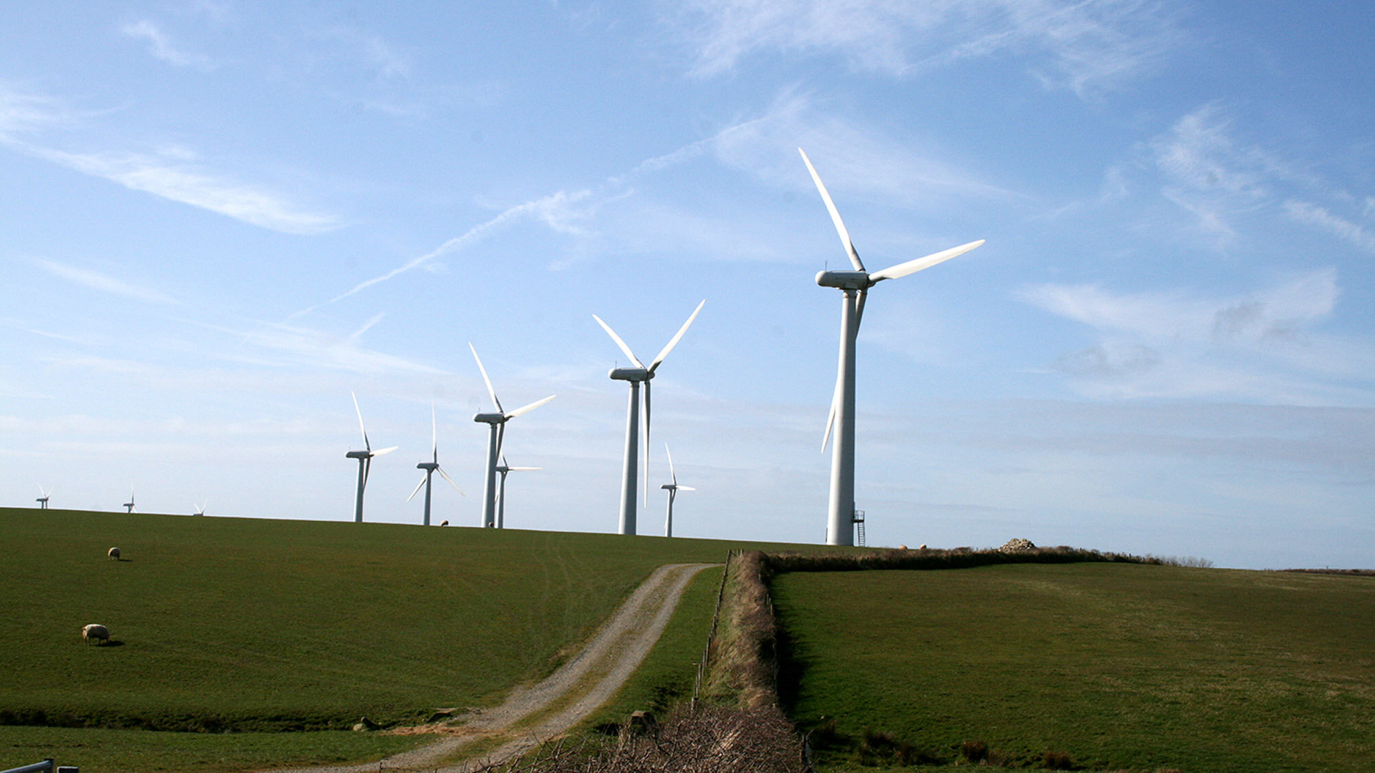 A line of wind Turbines on a rolling hill in Wales