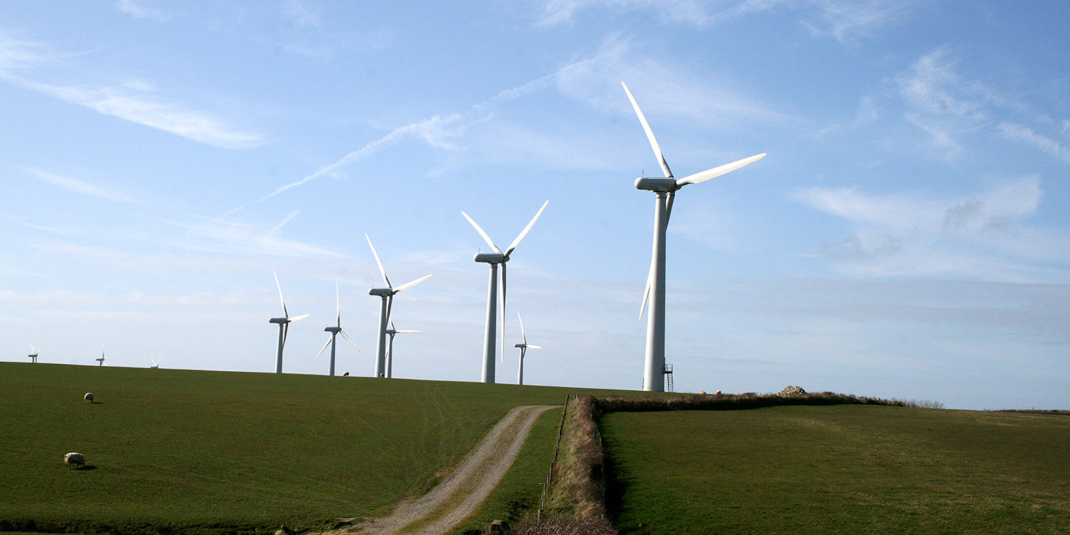 A line of wind Turbines on a rolling hill in Wales