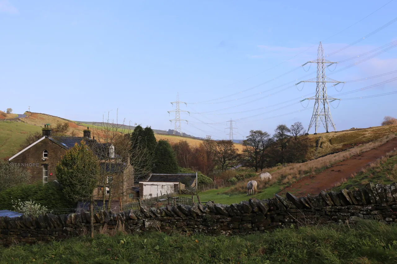 Protected rural landscape with overhead electricity lines; landscape architecture strategies aim to reduce visual impact in scenic countryside settings.