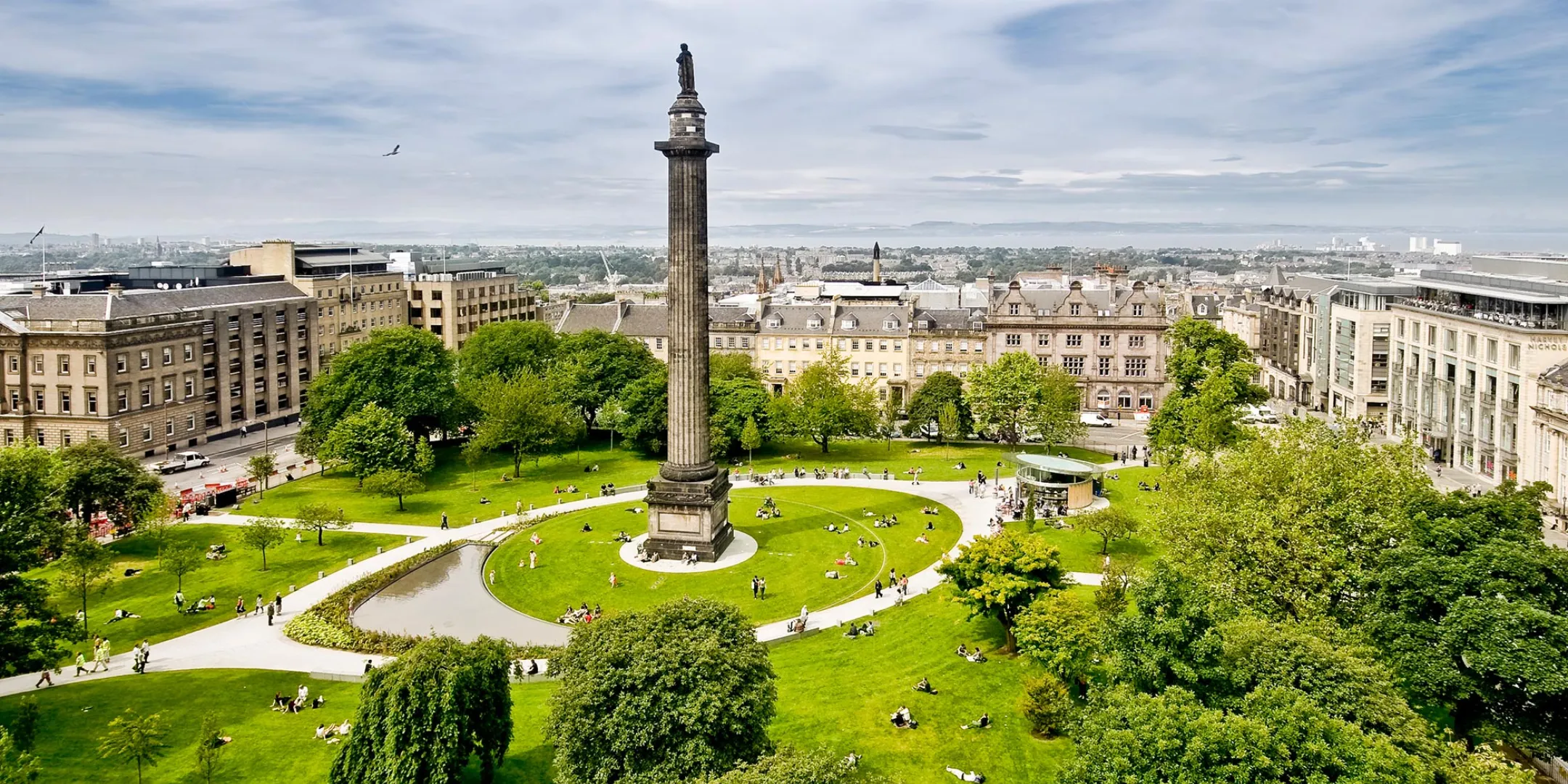 St Andrew Square aerial view with historic Melville Monument, tree planting, curving paths, and civic green space in Edinburgh.
