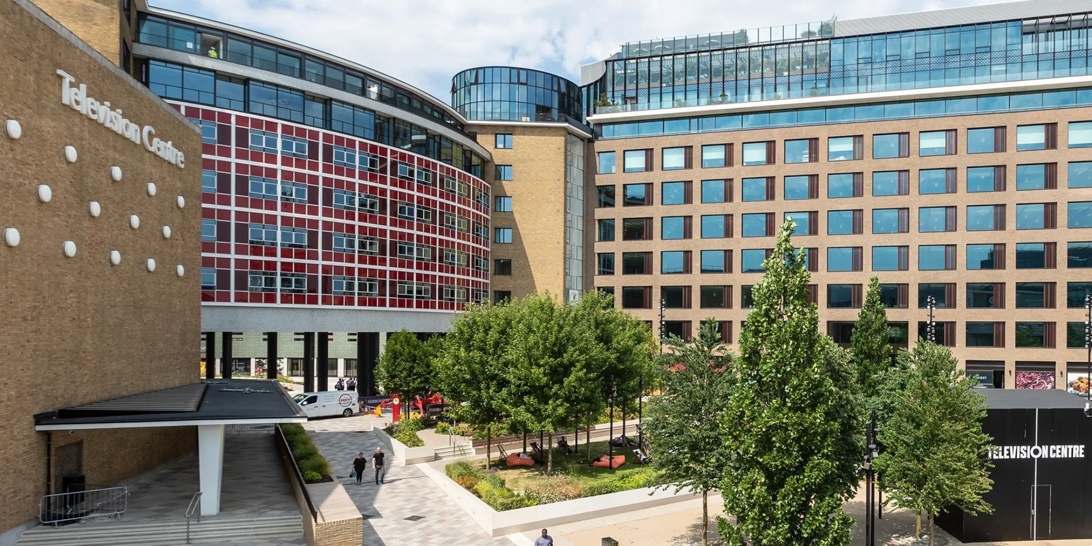 Television Centre plaza with mature trees, landscaped public spaces and surrounding office buildings.