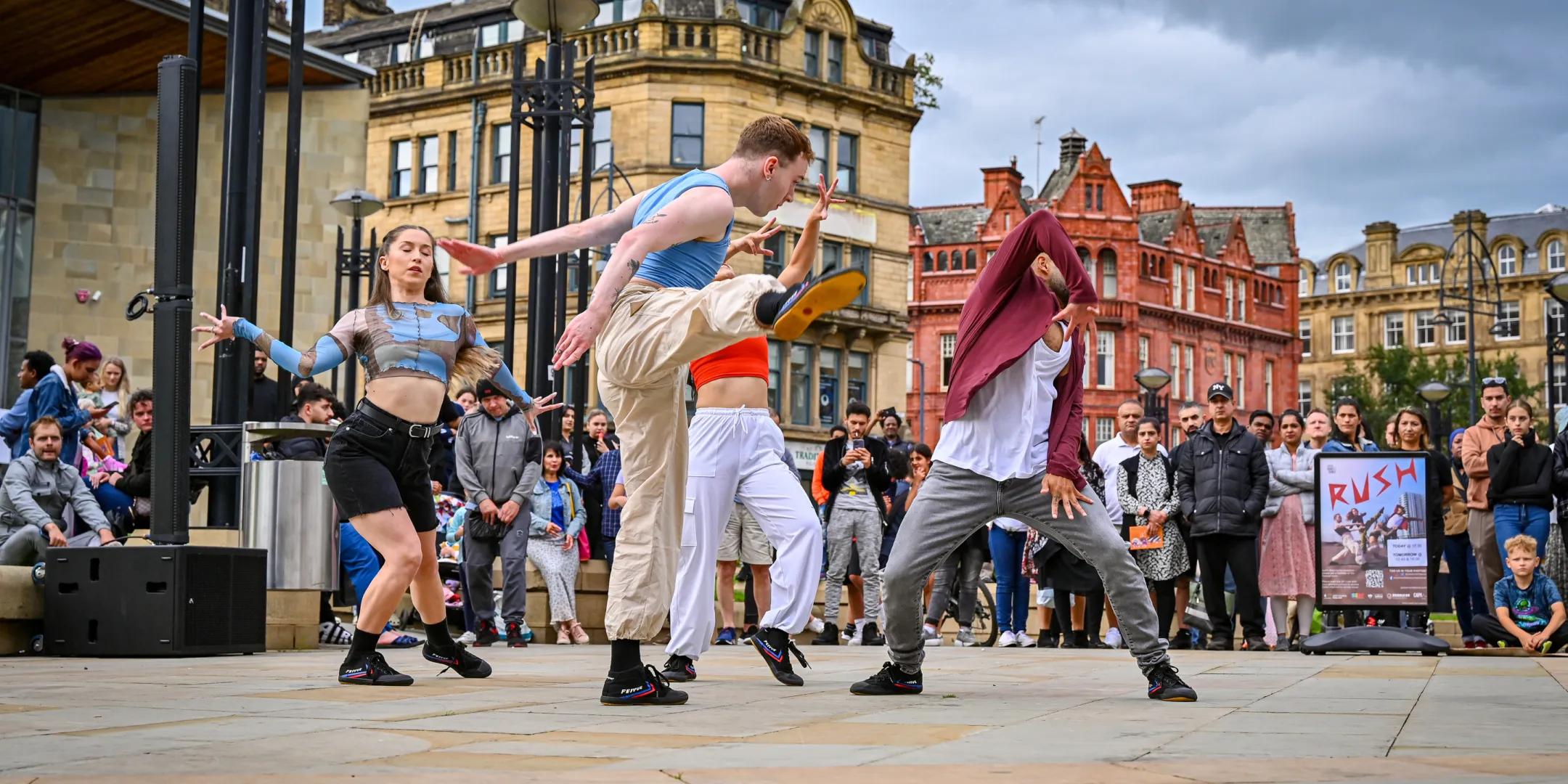 Street performers at Bradford City Park plaza for Bradford Festival. Activating urban public space through inclusive and adaptable landscape design by Gillespies.