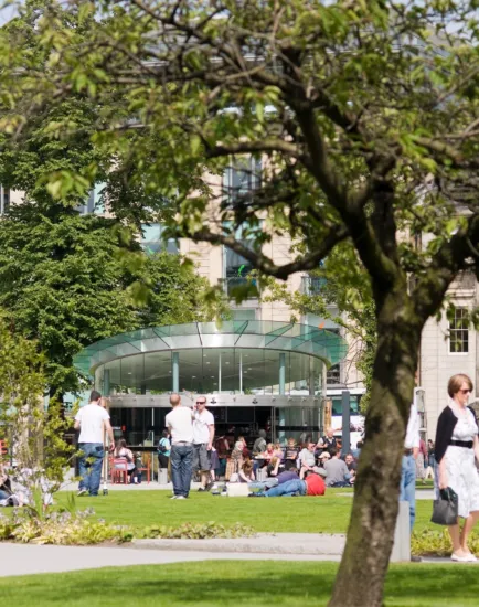 St Andrew Square landscape design with lawn, trees, and café pavilion promoting urban relaxation in Edinburgh city centre.