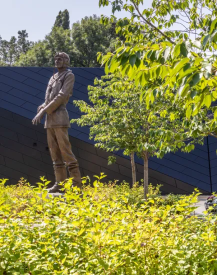A commemorative statue of Sir Keith Park set within layered planting