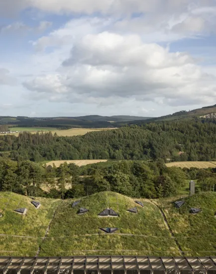 Macallan Distillery green roof blending with Scottish Highlands landscape, showcasing sustainable architecture and ecological landscape design.