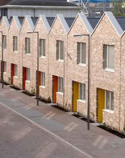 Anne Mews Barking shows sustainable streetscape design with brick terraced housing, shared surfaces, and integrated soft landscaping.