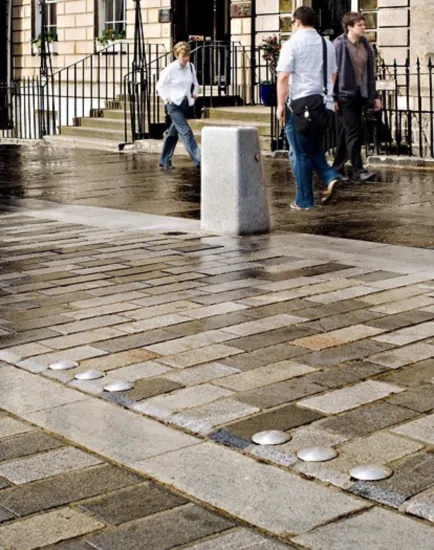 Castle Street paving detail showing tactile surfaces, bollards, and high-quality materials  in landscape-led urban street design.