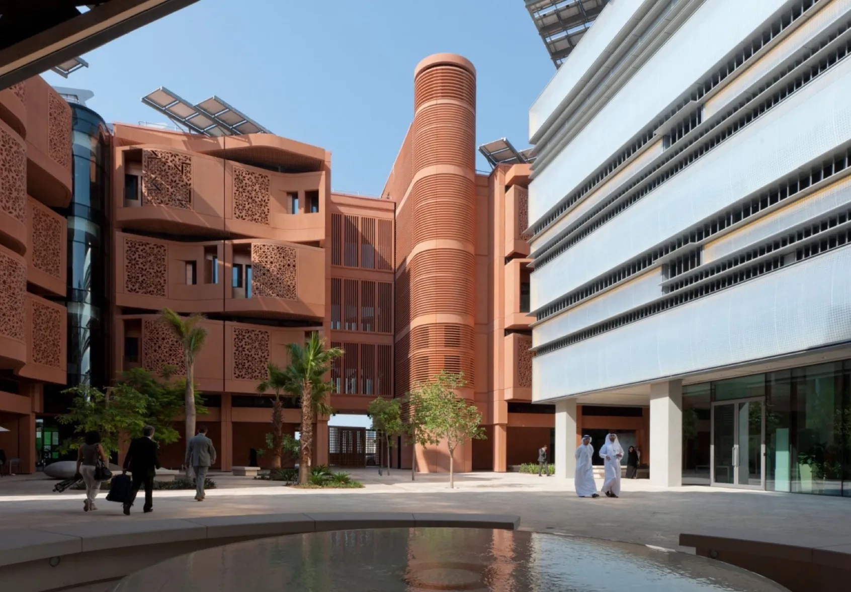 Shaded plaza at Masdar Institute, Abu Dhabi, with sustainable landscape design, passive cooling, and native desert planting.