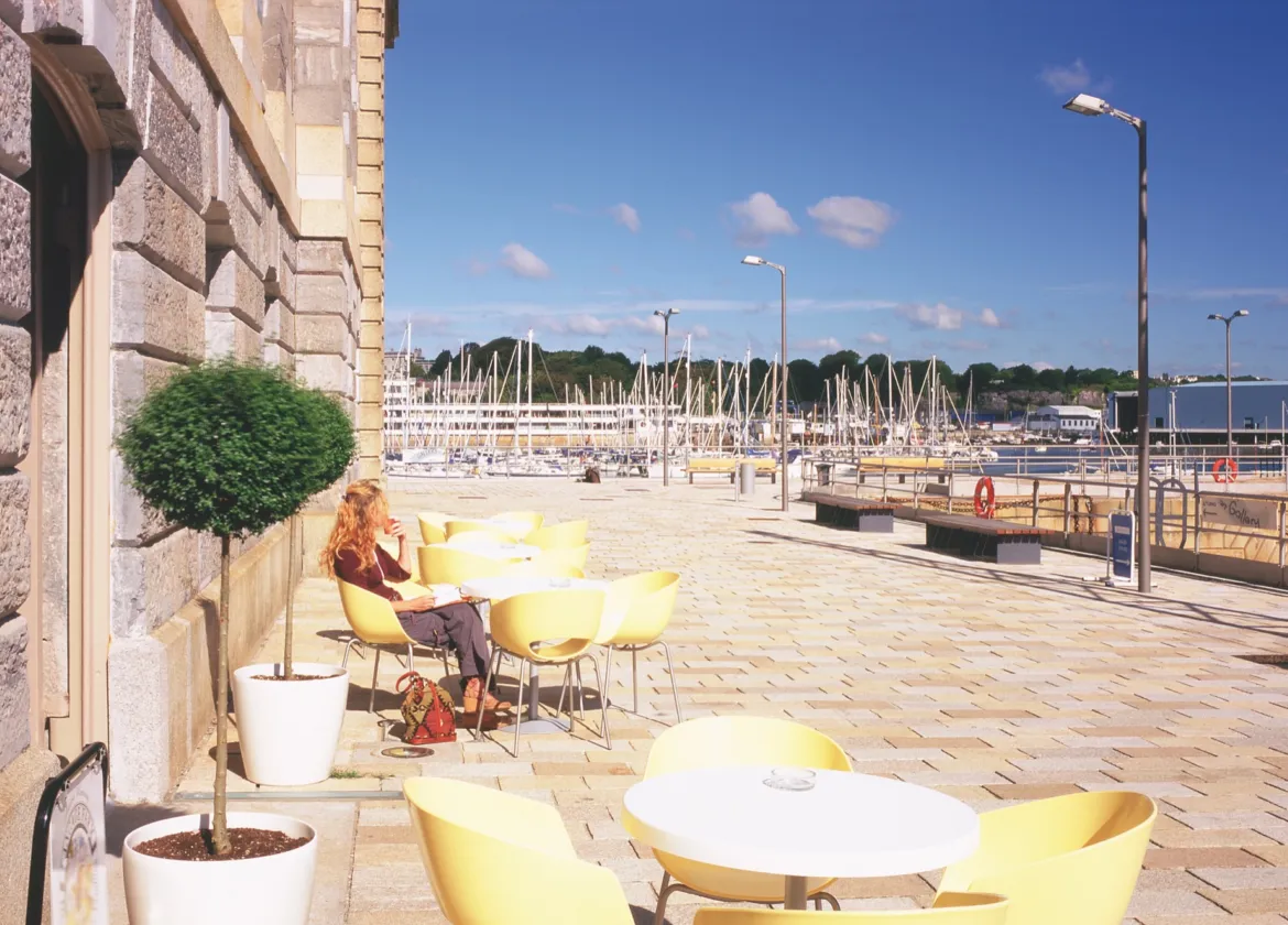 Royal William Yard waterfront landscape with marina views, outdoor seating, and historic stone architecture in Plymouth.