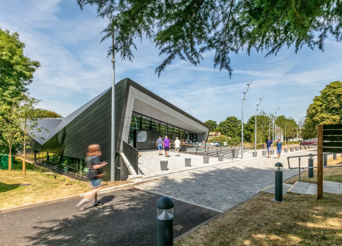 A gently contoured landscape frames the Battle of Britain Visitor Centre, creating a respectful and tranquil setting that responds to its historic context.