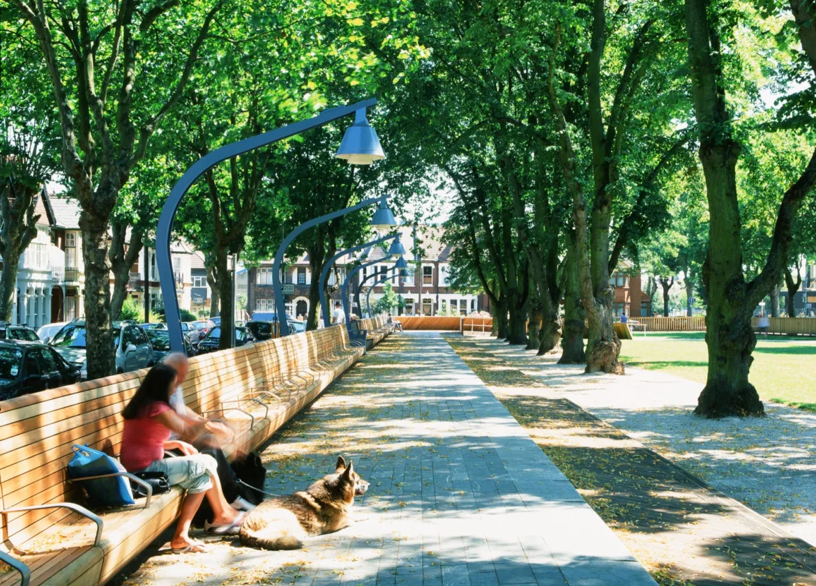 Linear park design at Warrior Square Gardens with tree-lined promenade, bespoke seating, and integrated urban landscape architecture.