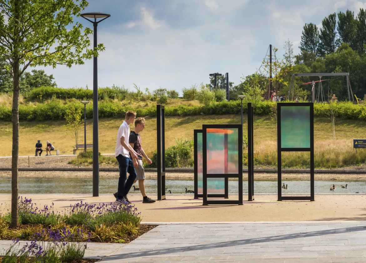 Contemporary landscape architecture at Southwater One with playful signage elements, native planting, pathways, and waterfront public realm design.