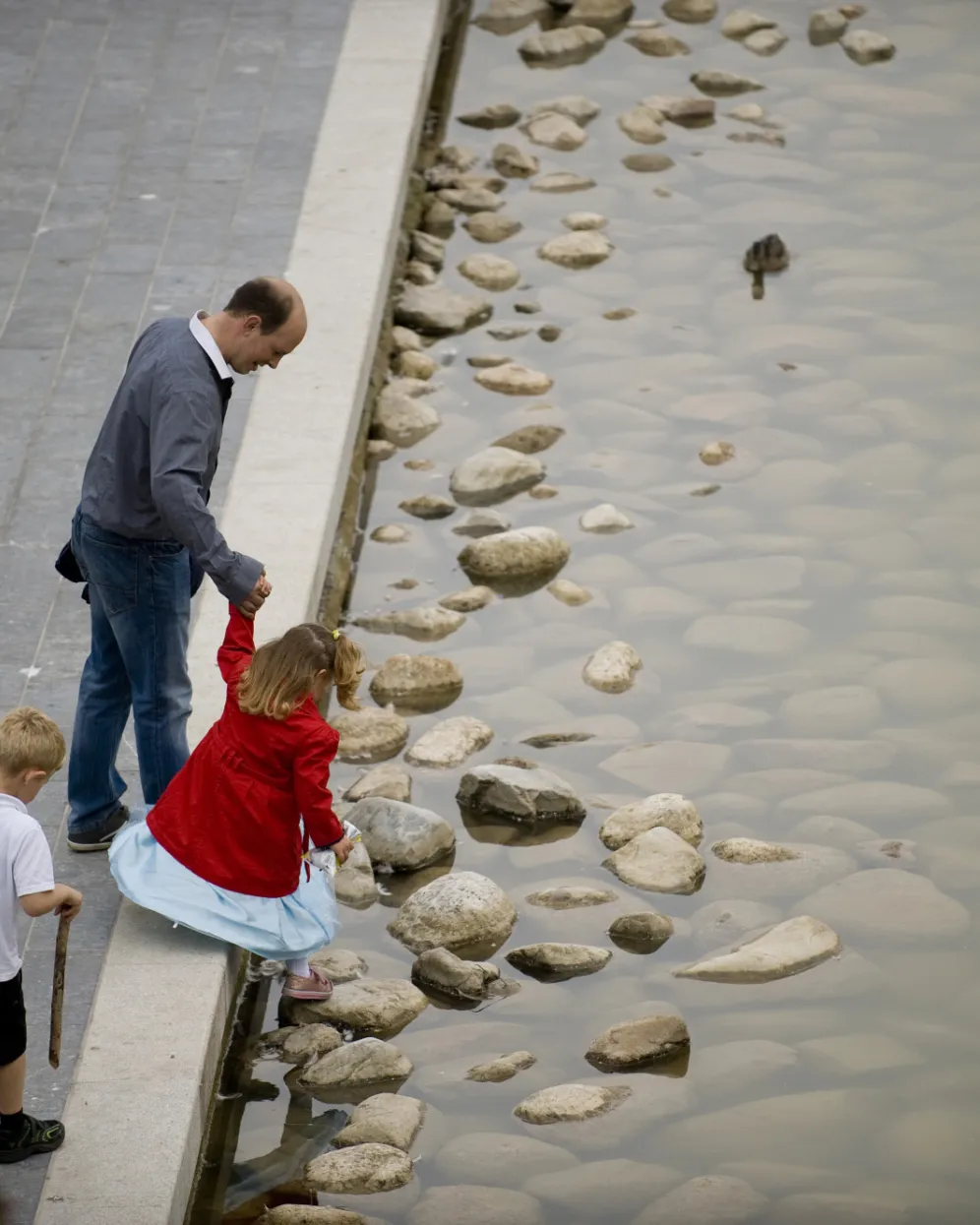 Urban water edge landscape at Southwater One with natural stone detailing and interactive public engagement in accessible design.