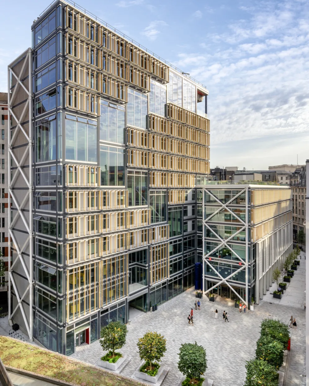 LSE Centre Building entrance and public realm with formal tree planting and surrounding seating in an open plaza. Integrated landscape design in academic setting by London based studio Gillespies.