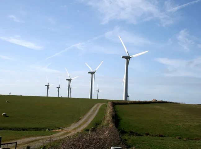 A line of wind Turbines on a rolling hill in Wales