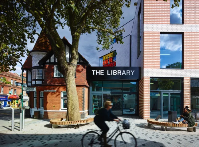 Willesden Green Library public realm with urban landscaping, integrated seating, and tree planting for placemaking.