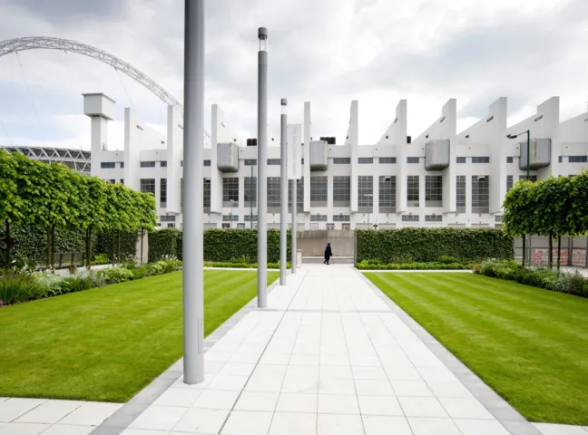 Brent Civic Centre landscape design with pleached trees, formal lawns, and linear paving framing iconic Wembley architecture.