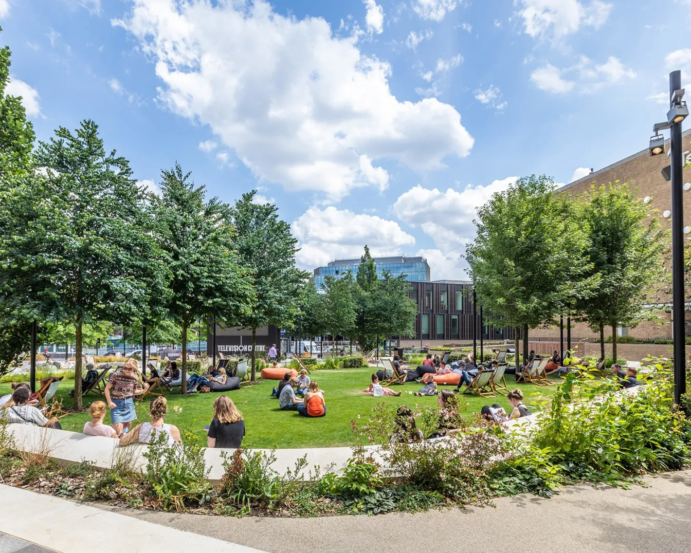 Television Centre landscape garden with trees, lawn, and seating areas designed for urban relaxation and community gathering.
