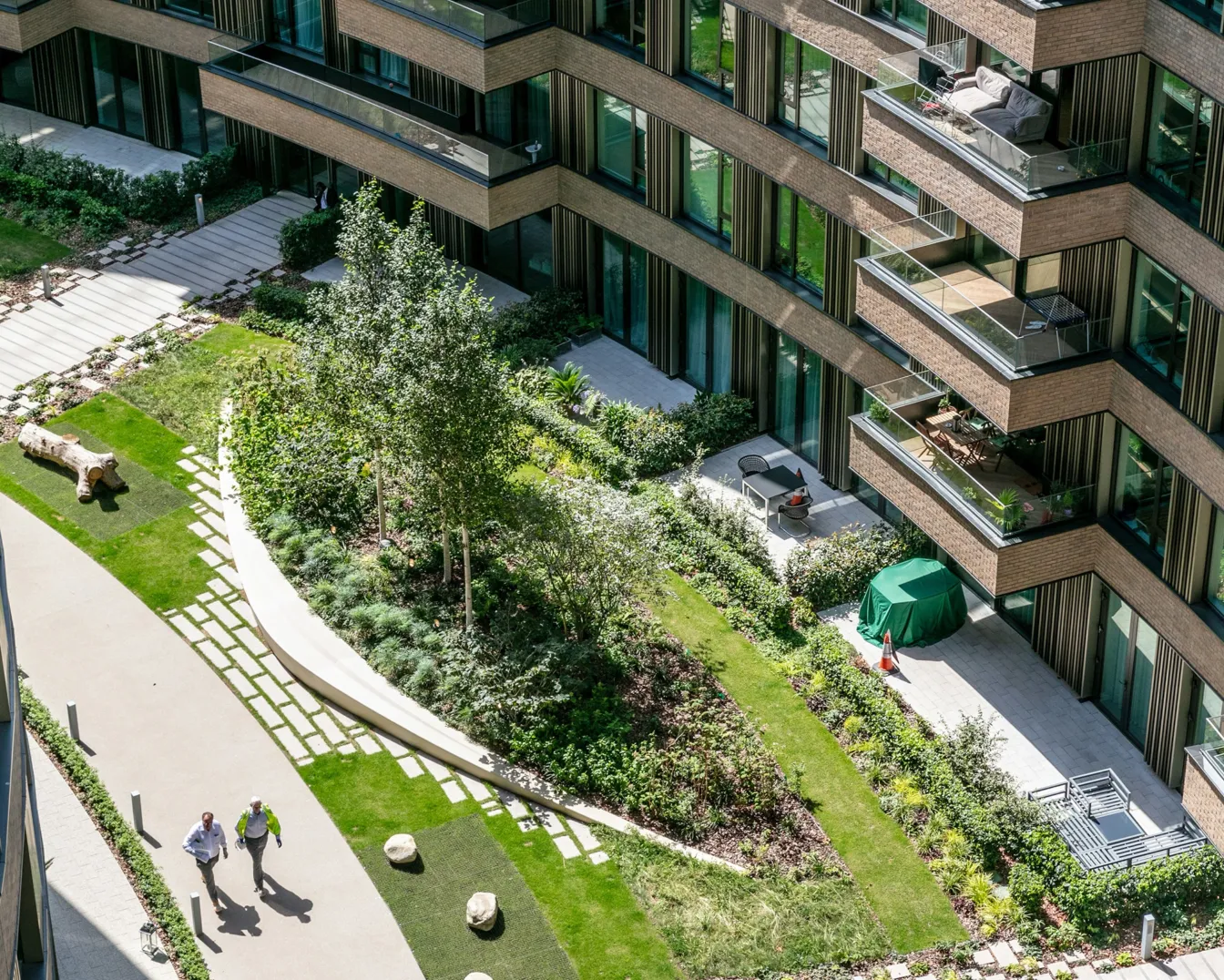 Aerial view of a contemporary residential courtyard with landscaped gardens, terraces and walkways.