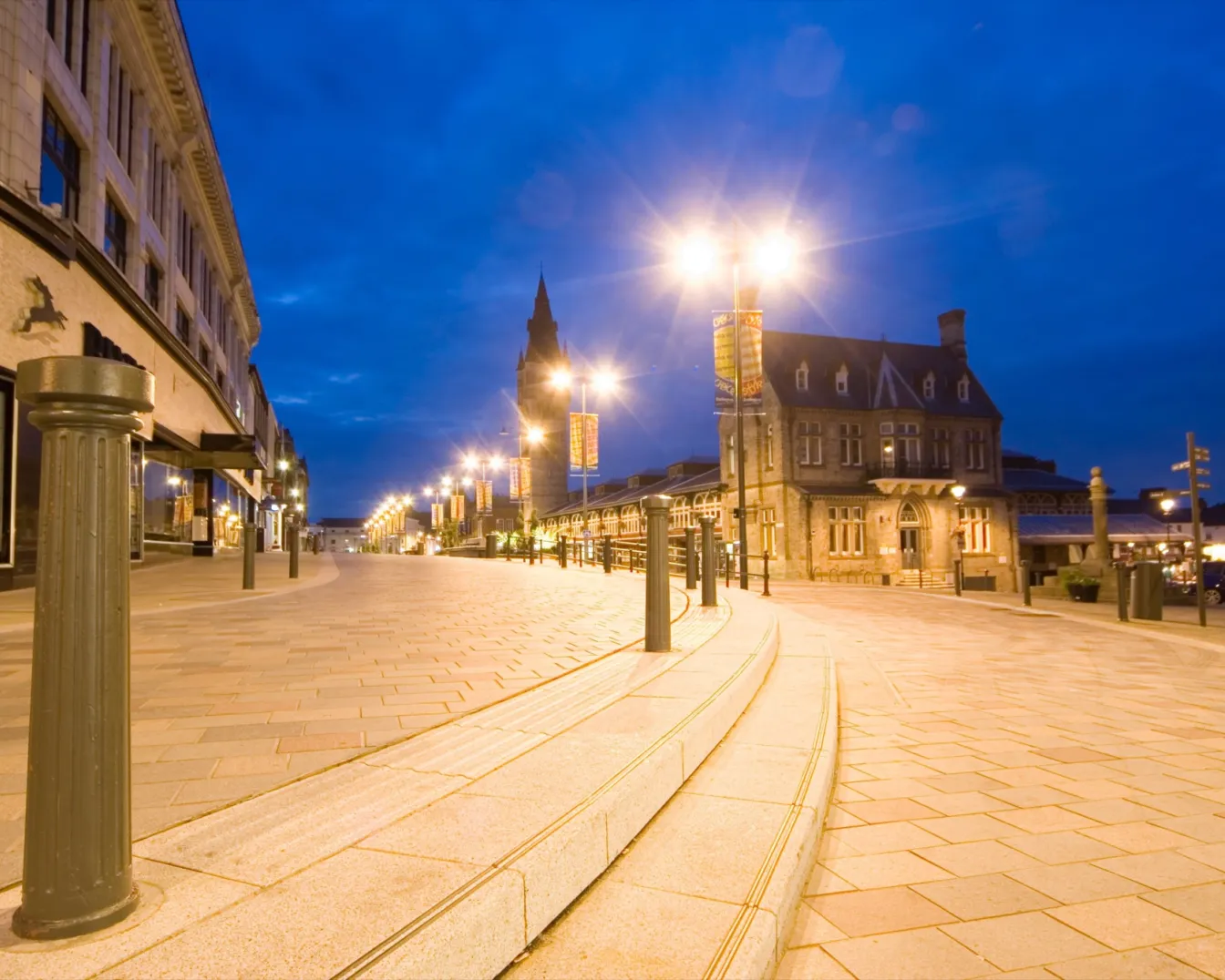 Darlington Pedestrian Heart at night with heritage lighting, stone paving, and inclusive landscape architecture by Gillespies in historic town centre.