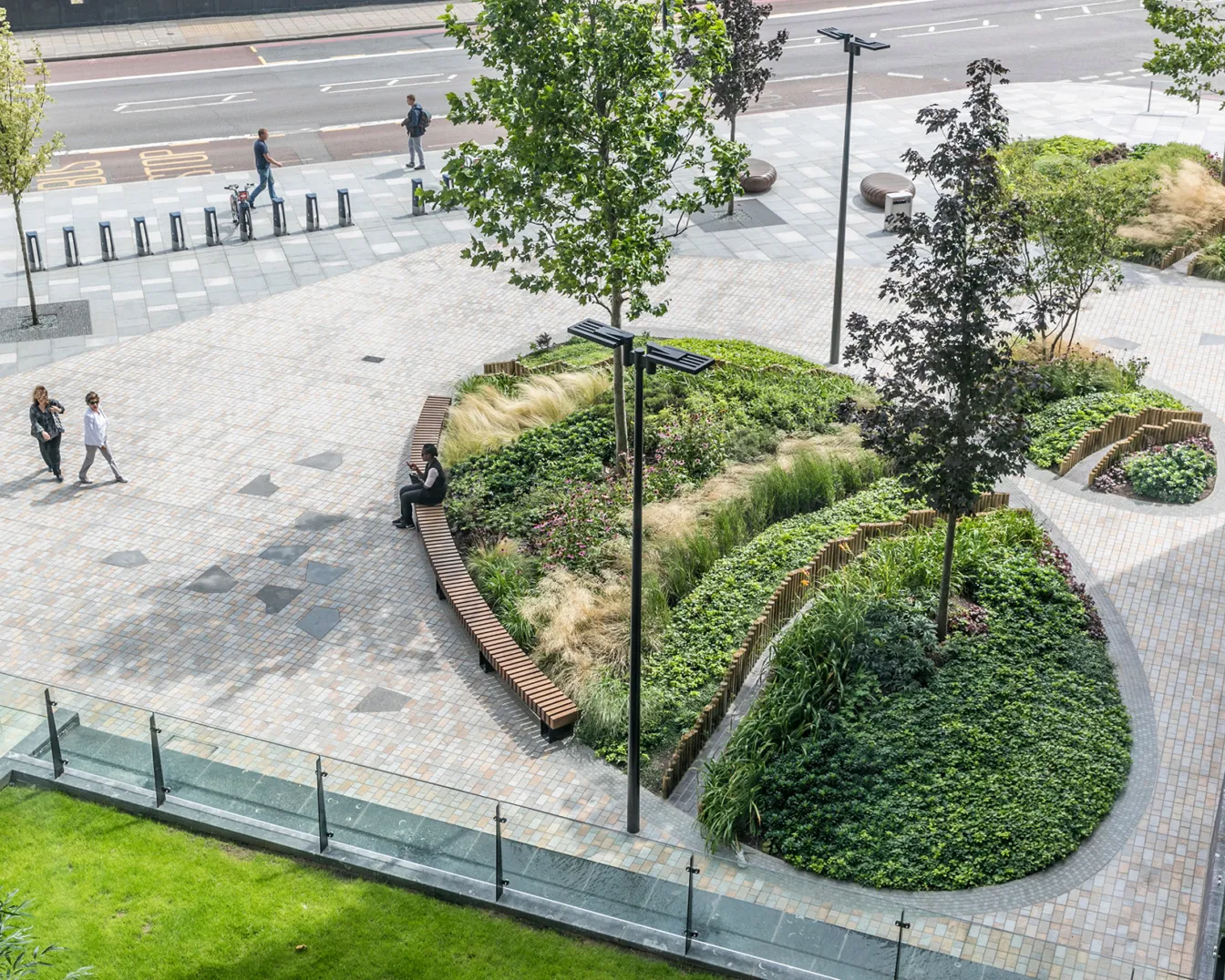 Riverlight residential landscape design with curved planting beds, seating, and urban paving in South London public realm.
