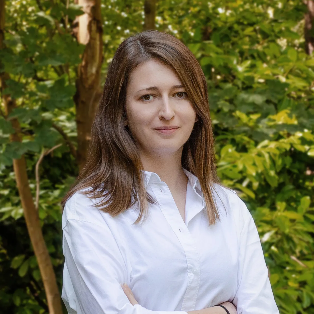 Katarzyna Machaj, Senior Landscape Architect, standing with her arms crossed in a woodland setting