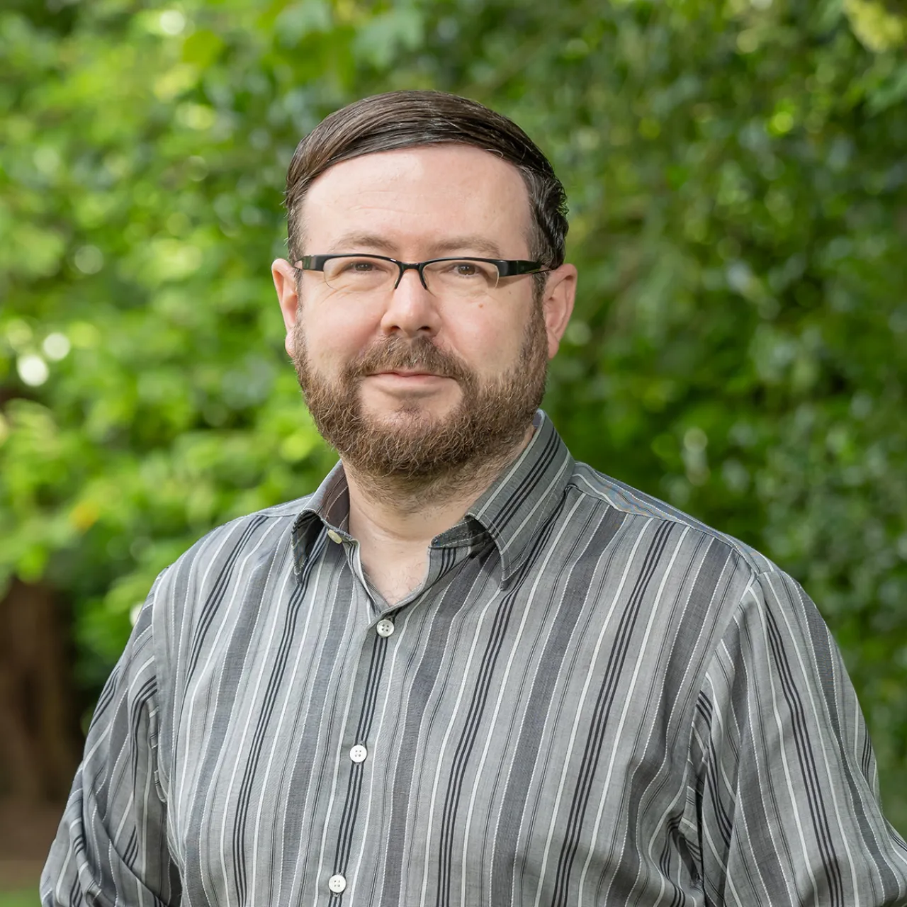 Bill Basterfield, Associate Partner at Gillespies' Oxford studio, standing in a woodland setting