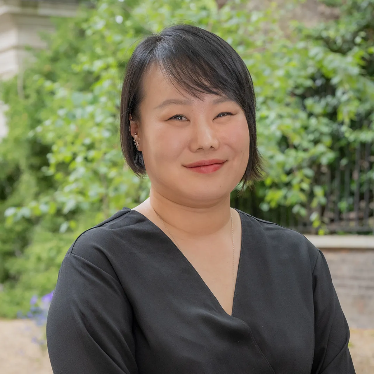Hana Shin, Landscape Architect at Gillespies' London studio, smiling in an urban space