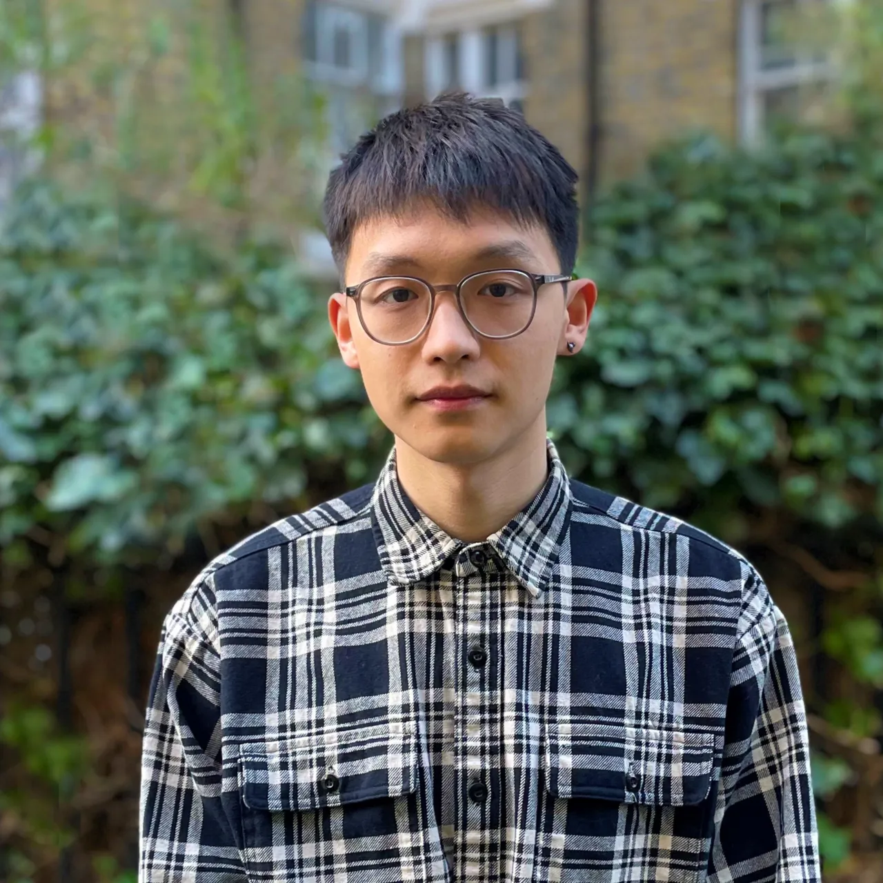 Tianyu Yu, a young Graduate Landscape Architect, standing in a parkland setting in London