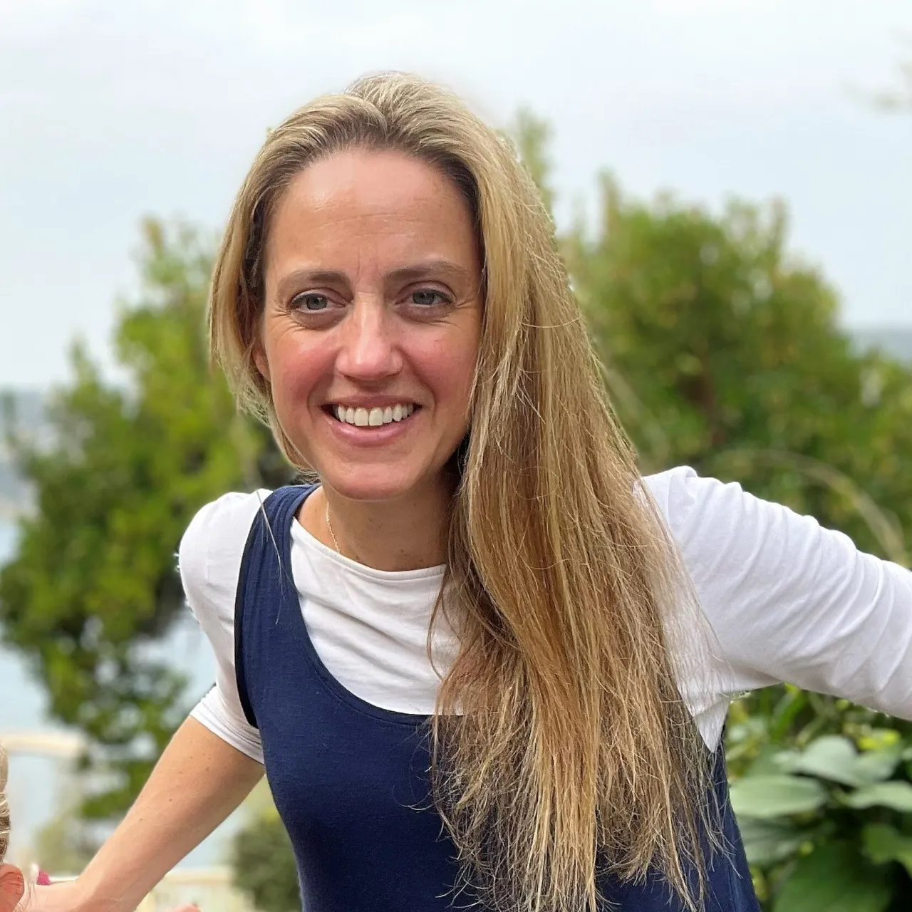 Samantha Leathers, Associate Partner and Head of Landscape Planning for the south region, smiling in a green setting