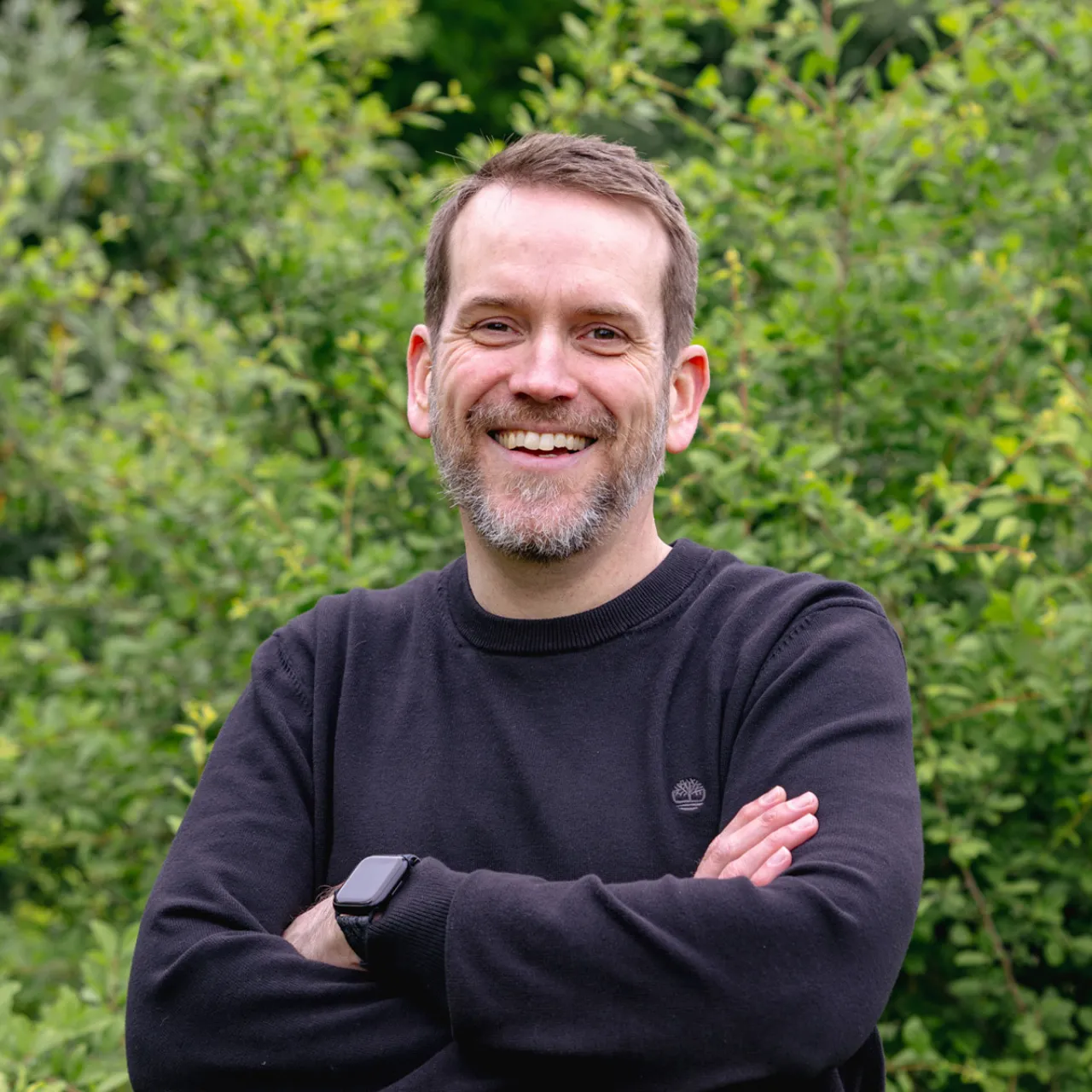 Oliver Clarke, Associate and Landscape Architect at Gillespies' Leeds studio, laughing in a parkland landscape