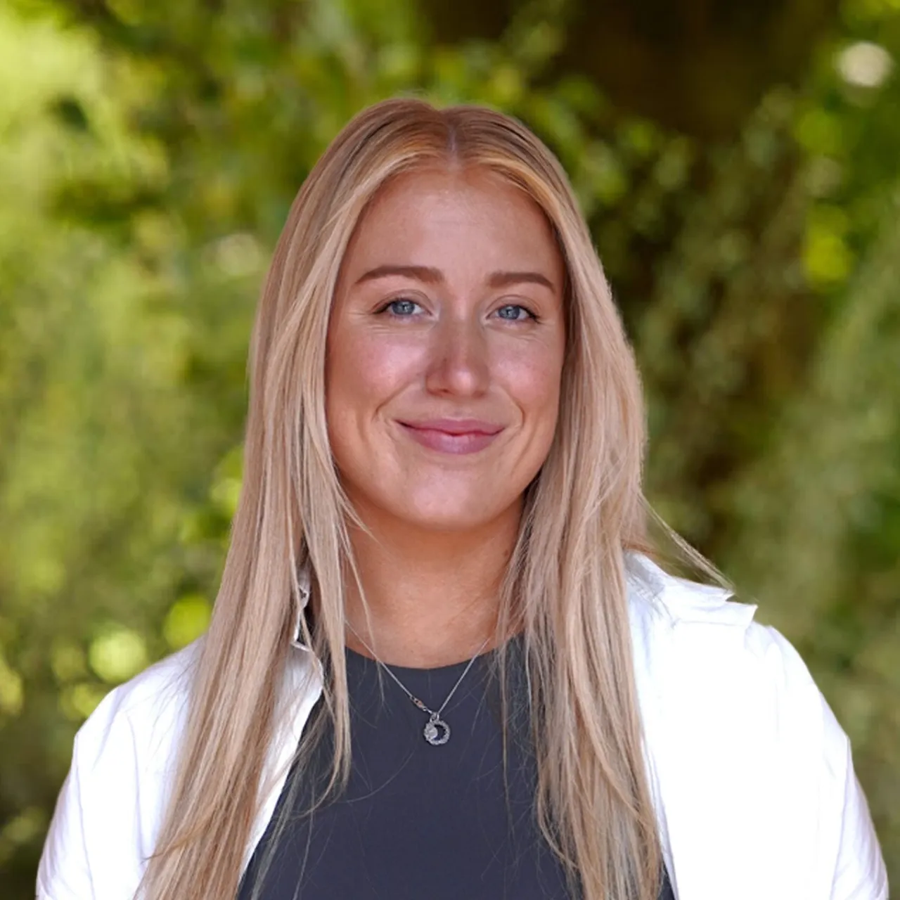Headshot of Kate Elvidge, landscape architect in Leeds, smiling in a parkland setting