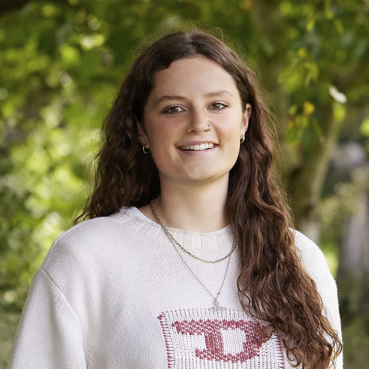 Headshot of Ellie Watson, Junior Landscape Planner, smiling in a parkland setting in Manchester