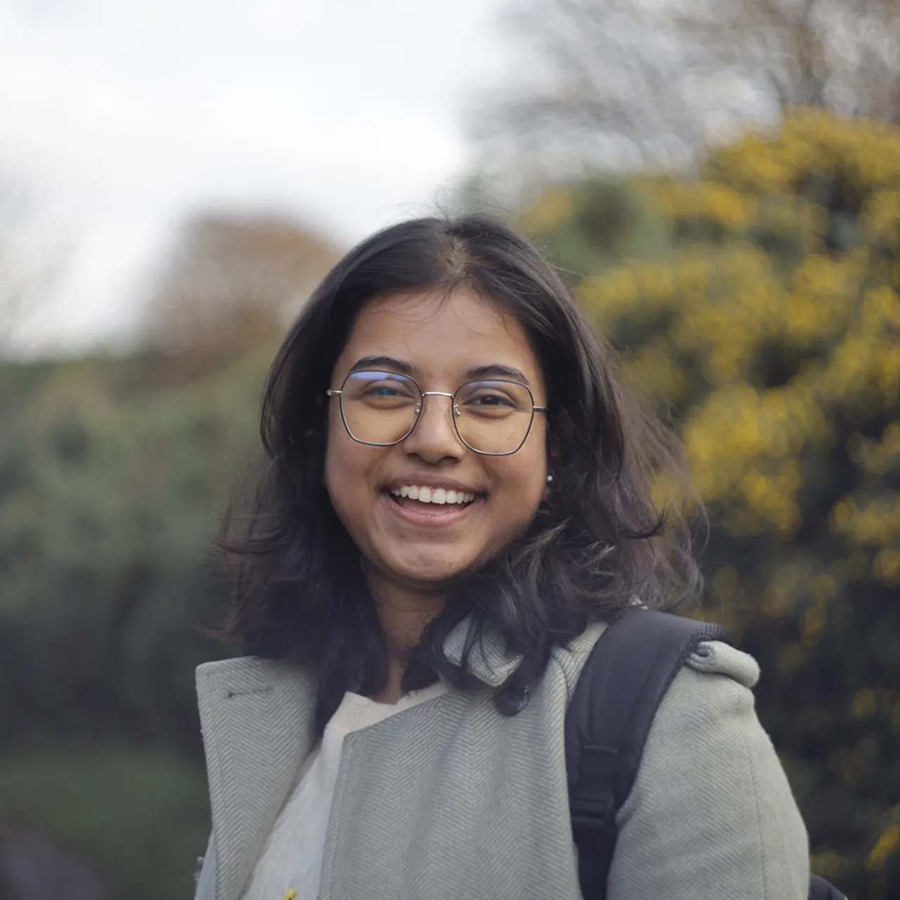 Landscape architect Jahnabi Barua smiling in a field