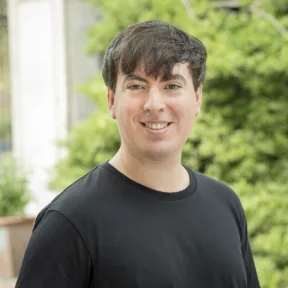 Giacomo Guzzon, Head of Planting at Gillespies, smiling in an urban space in London