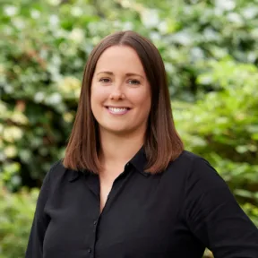 Katie Hodgeson, Associate landscape architect based in Gillespies’ Leeds studio, smiling at the camera from a parkland in Leeds.